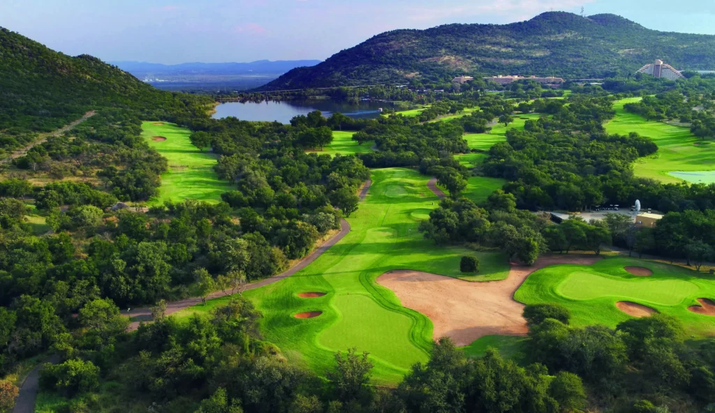 A scenic view of the lush green fairways and surrounding landscape at Sun City's Gary Player Country Club in South Africa